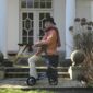 Elderly woman with walker on house steps