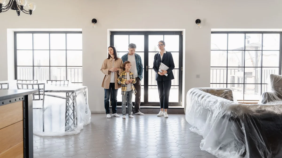 Gezin verkent nieuw huis met agent, benadrukt moderne interieurs.